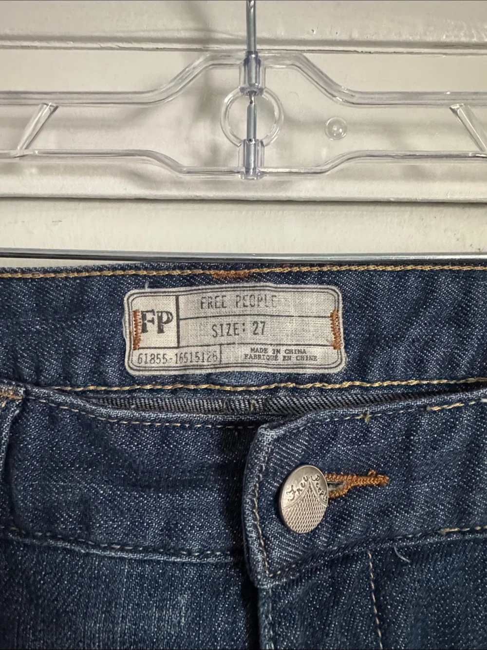Free People skinny jeans with crochet lace and patching details. 32” inseam.